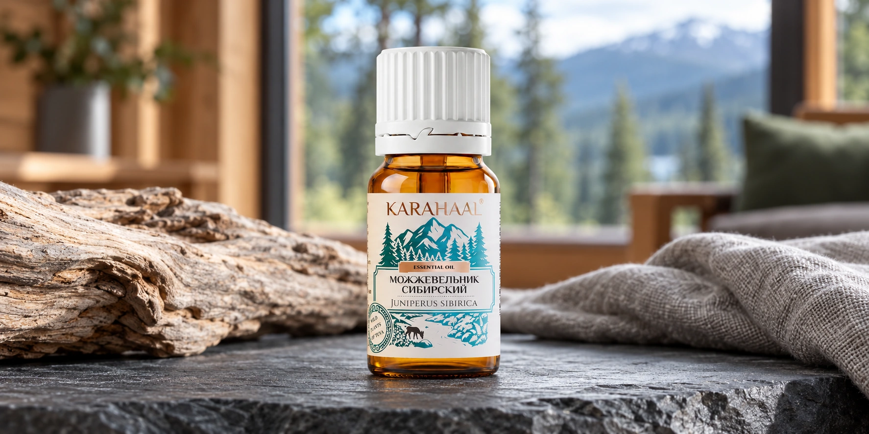 Оригинальный флакон Karahaal «Можжевельник сибирский» на сером камне, рядом с деревом и льняной тканью.